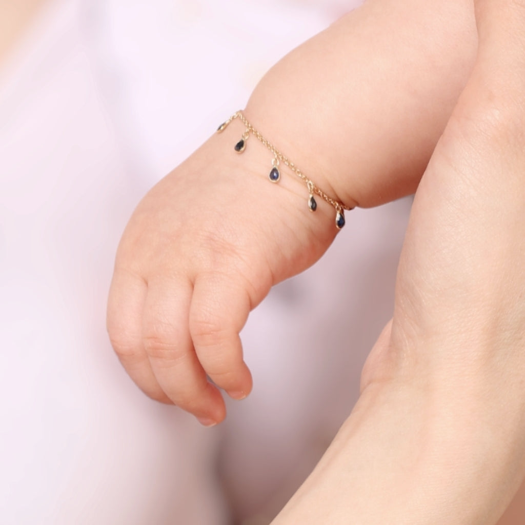 Baby hand with pear shape sapphire bracelets